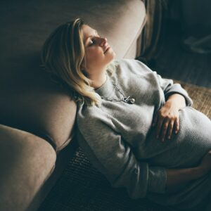 Cozy portrait of pregnant woman resting at home